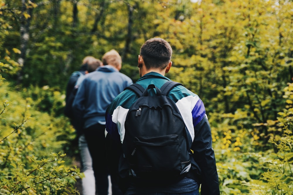 man in black jacket carrying black backpack