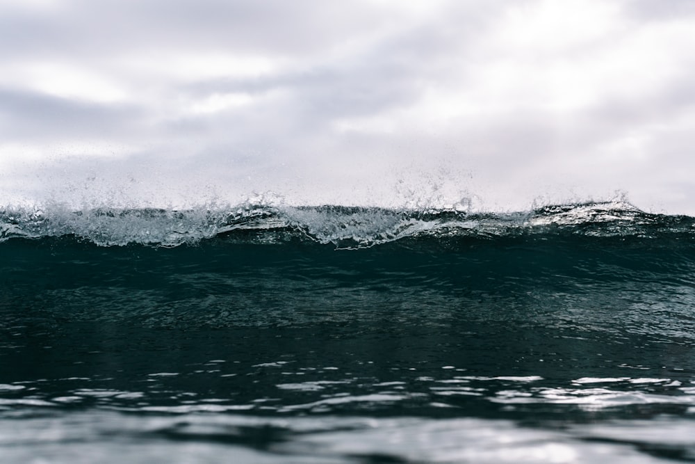 ocean waves under cloudy sky during daytime