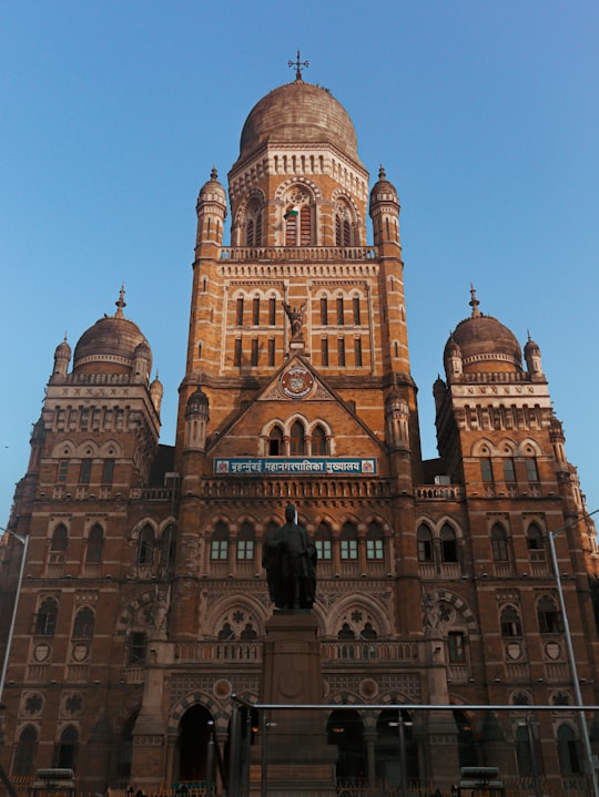 brown concrete building under blue sky during daytime in Municipal Corporation Building India