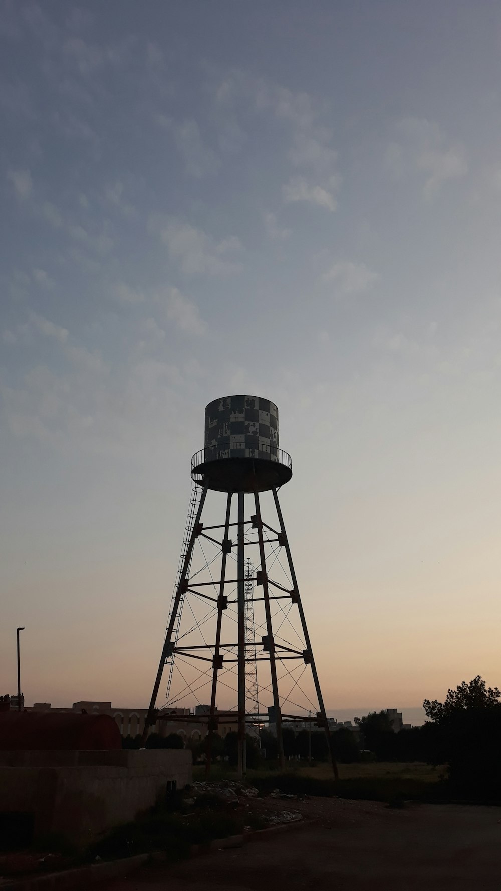 black metal tower under white clouds