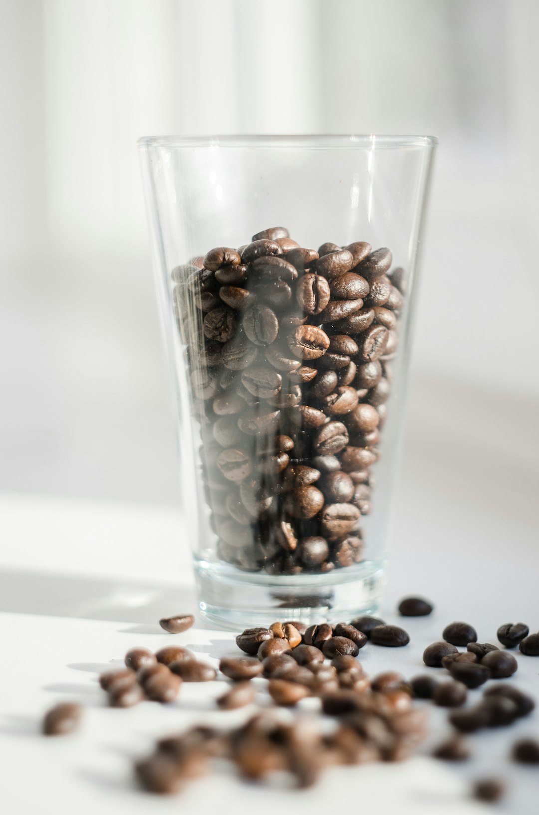 brown coffee beans in clear drinking glass