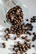 Artisan coffee beans spilling from a burlap sack with warm natural light highlighting their texture.