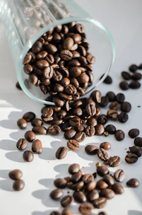 Artisan coffee beans spilling from a burlap sack with warm natural light highlighting their texture.