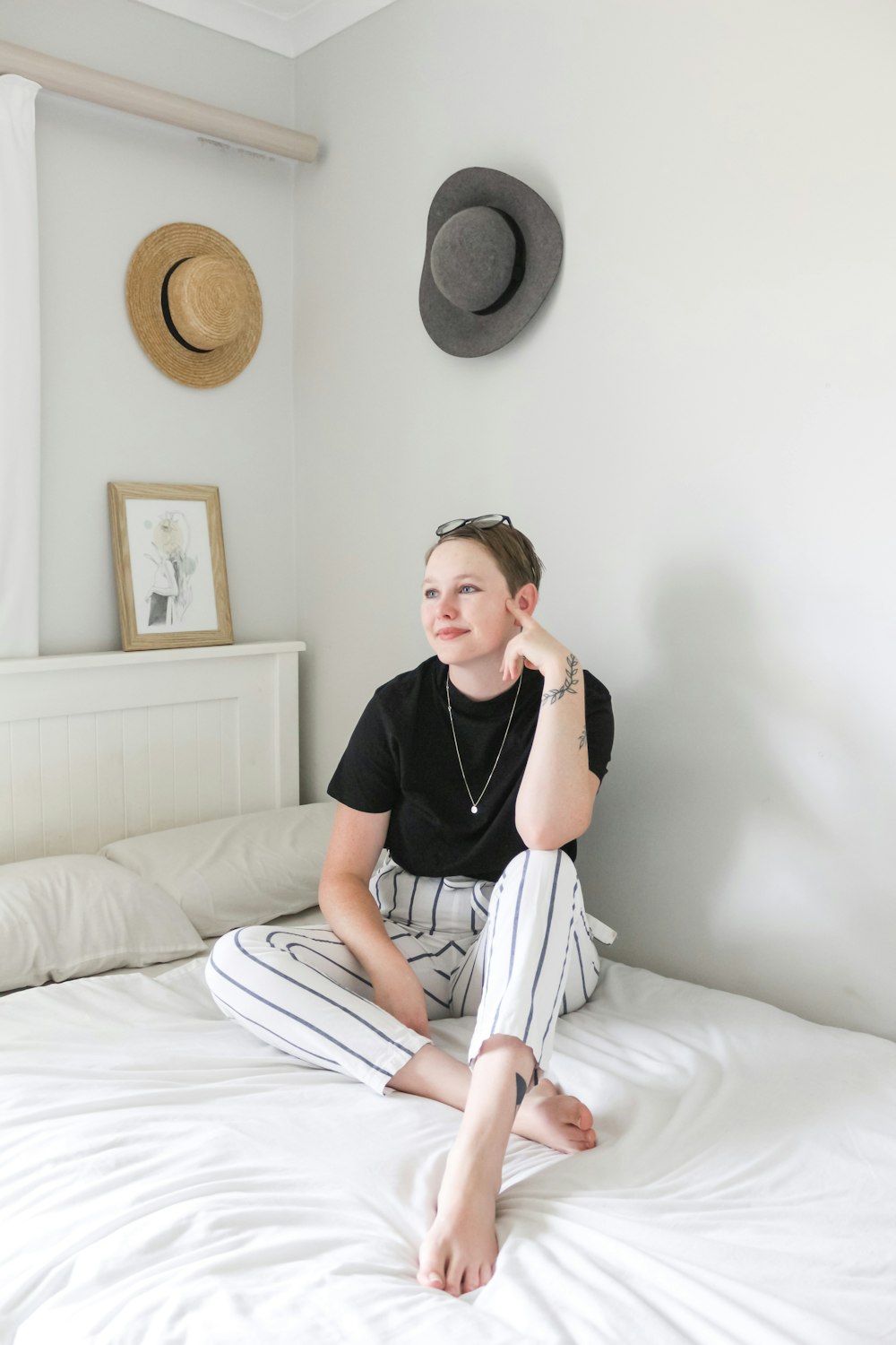 woman in black crew neck t-shirt sitting on bed