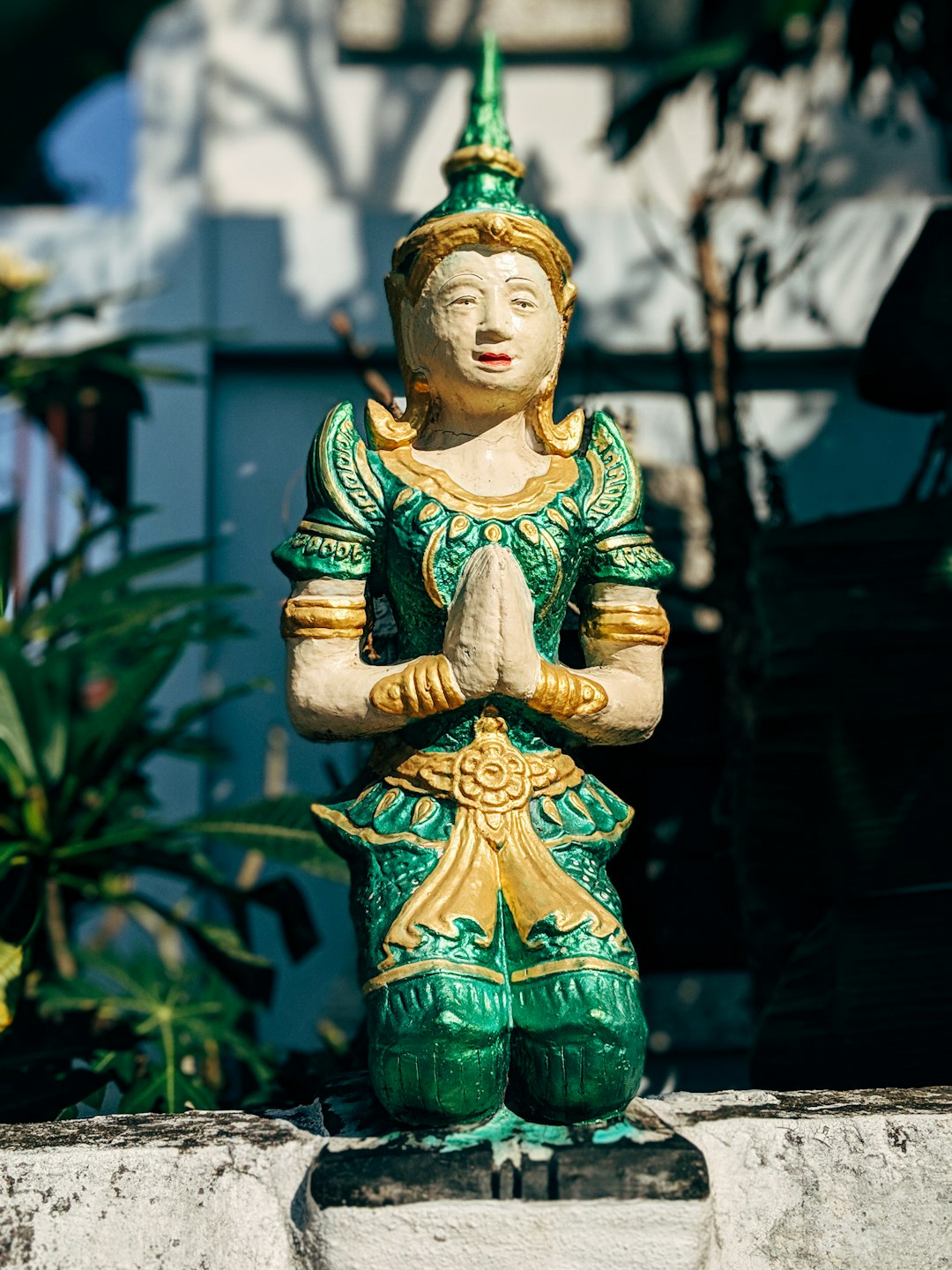 green and yellow ceramic buddha figurine