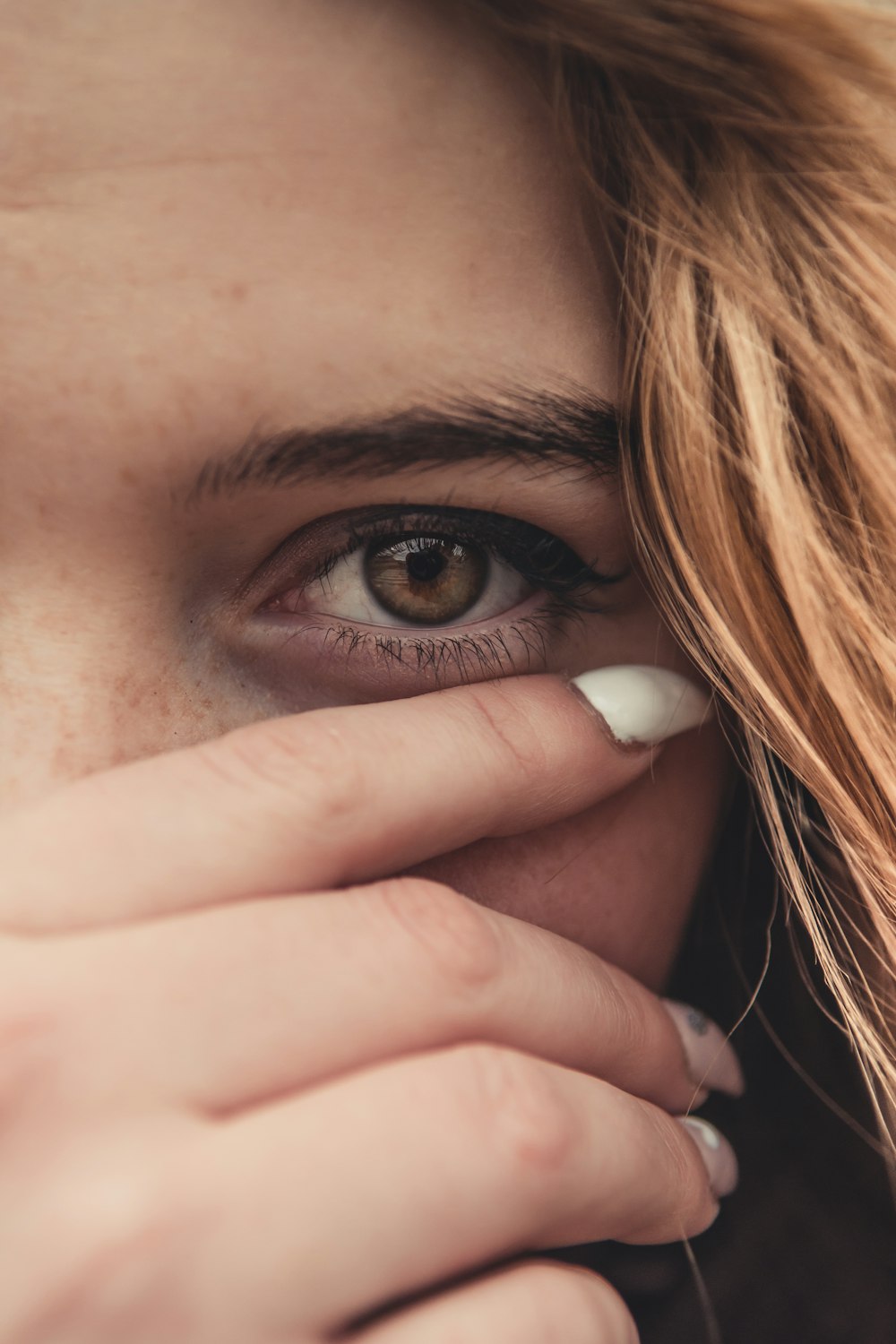 womans brown hair covering her face