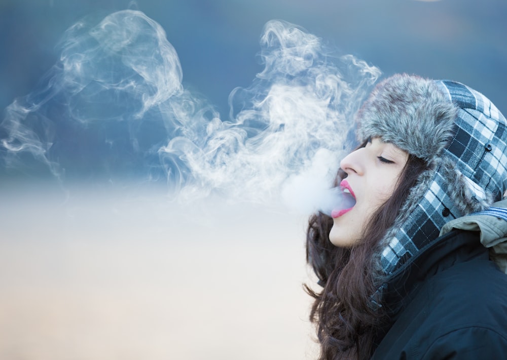 woman in black jacket with white clouds in the background