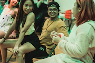 A group of happy patients of different ages sharing a light moment in the clinic's vibrant lobby.