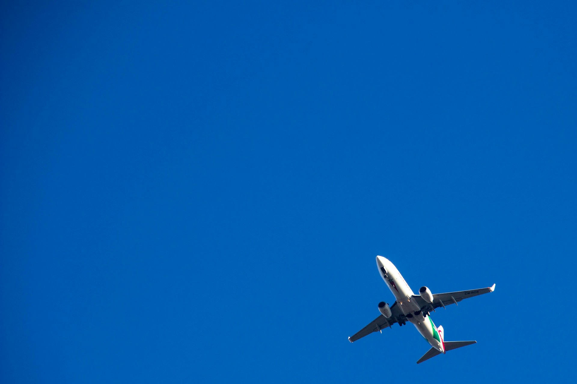 white and black airplane in mid air during daytime