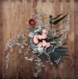 Chic floral centerpiece with cream roses and delicate baby's breath in a glass vase.