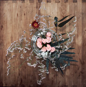 Chic floral centerpiece with cream roses and delicate baby's breath in a glass vase.