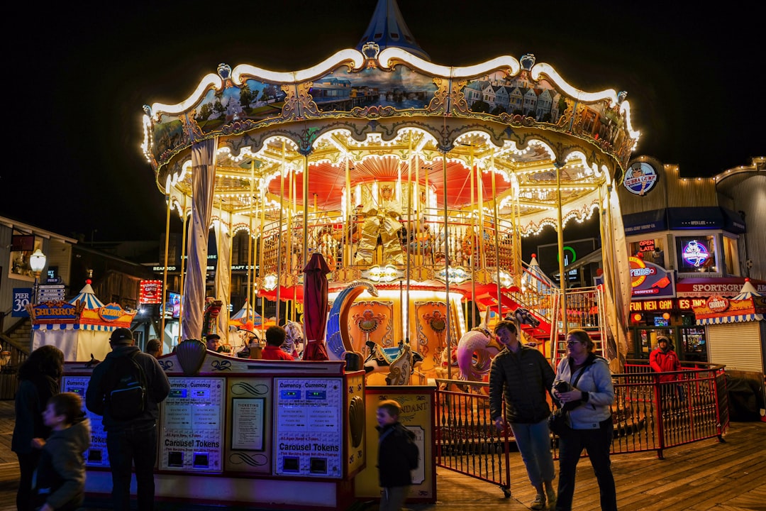 people riding on carousel during night time