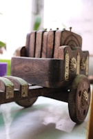 Close-up of the sturdy iron frame and natural wood details of the wine cart.