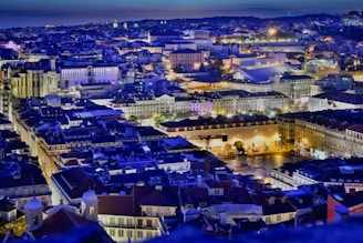 A vibrant cityscape with illuminated skyscrapers and busy streets at twilight, capturing a travel vibe.