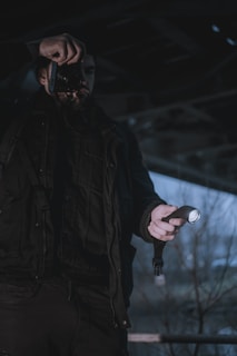 A candid shot of a happy customer holding their new paranormal investigation equipment outdoors at dusk.