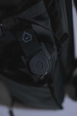 A close-up shot of a myrabag backpack resting on a wooden bench with soft natural light highlighting its texture.