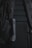 A close-up view of a backpack with visible padded sections and adjustable straps. There is a black cylindrical object attached to the strap, which appears to be a small flashlight.