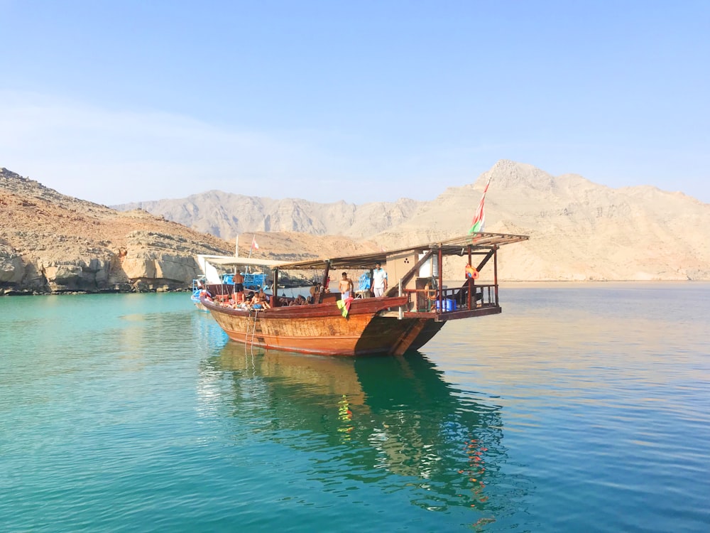 brown boat on body of water during daytime