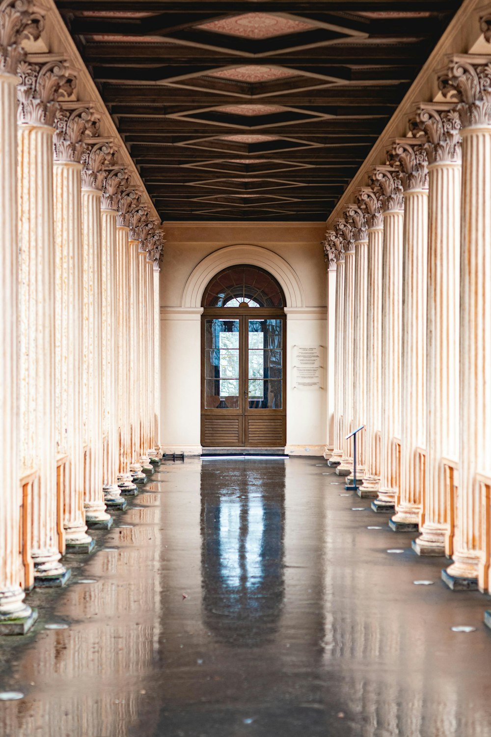 white and brown hallway with glass windows