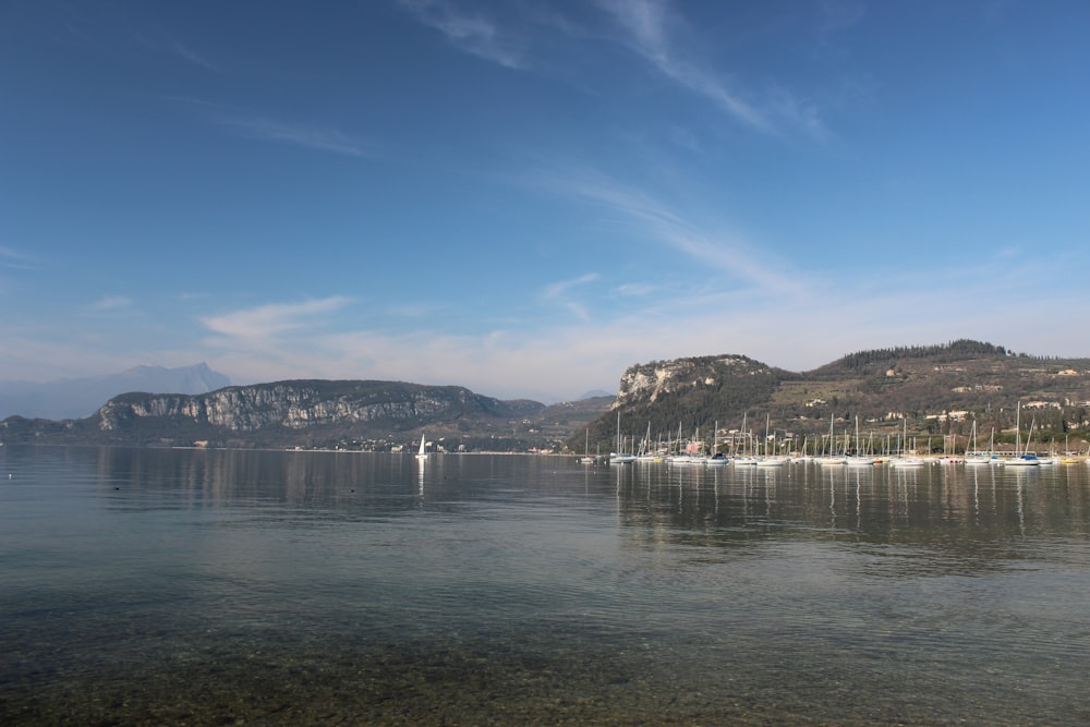 body of water near mountain under blue sky during daytime