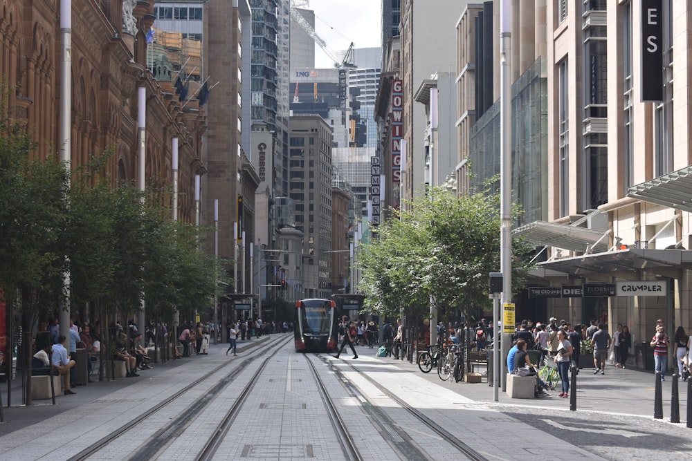 people walking on sidewalk near buildings during daytime