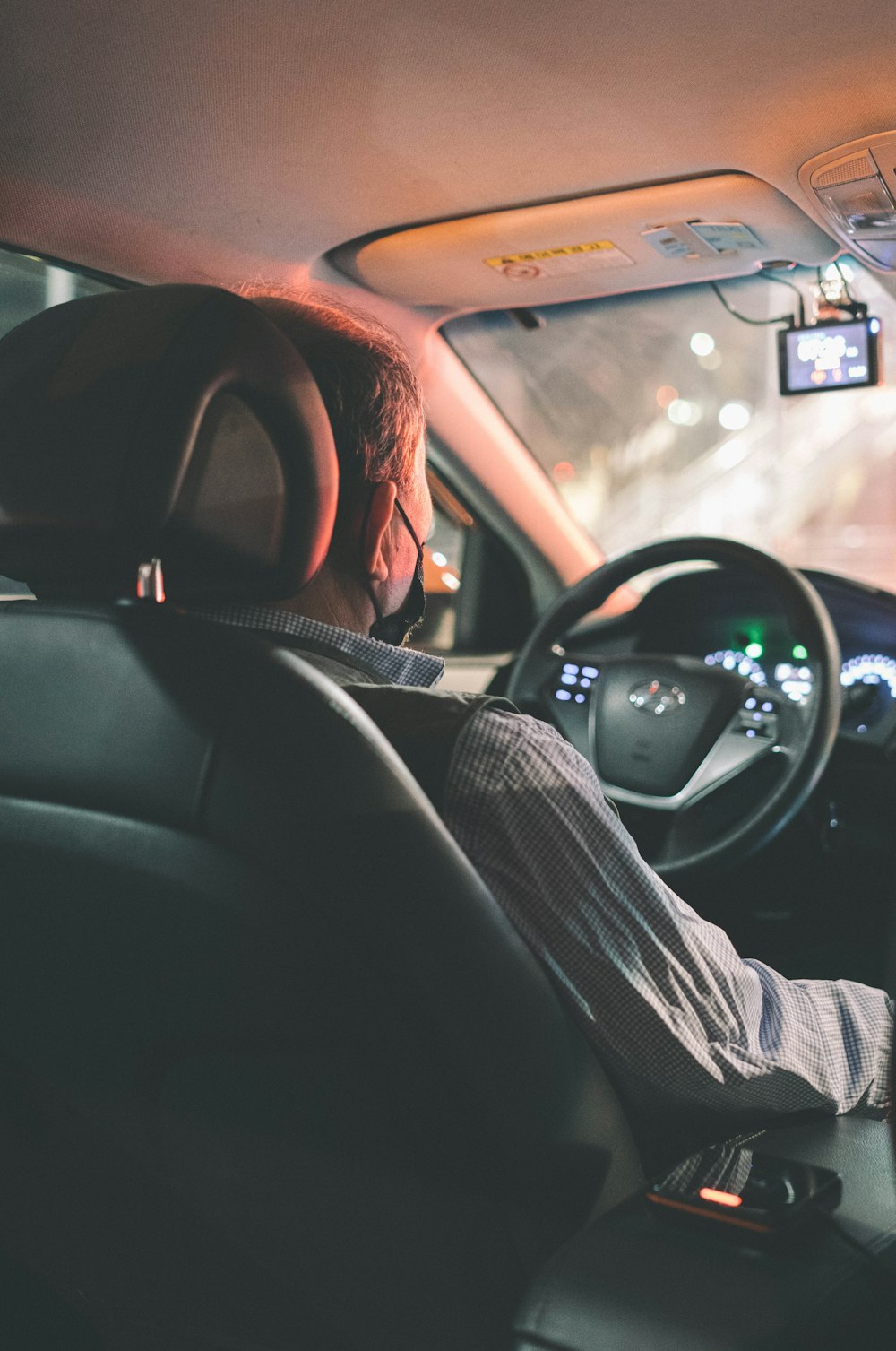 man in black and white striped long sleeve shirt driving car