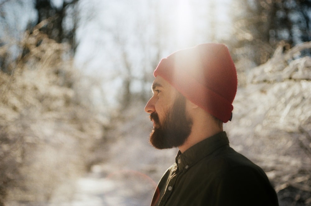 man in red knit cap and black jacket