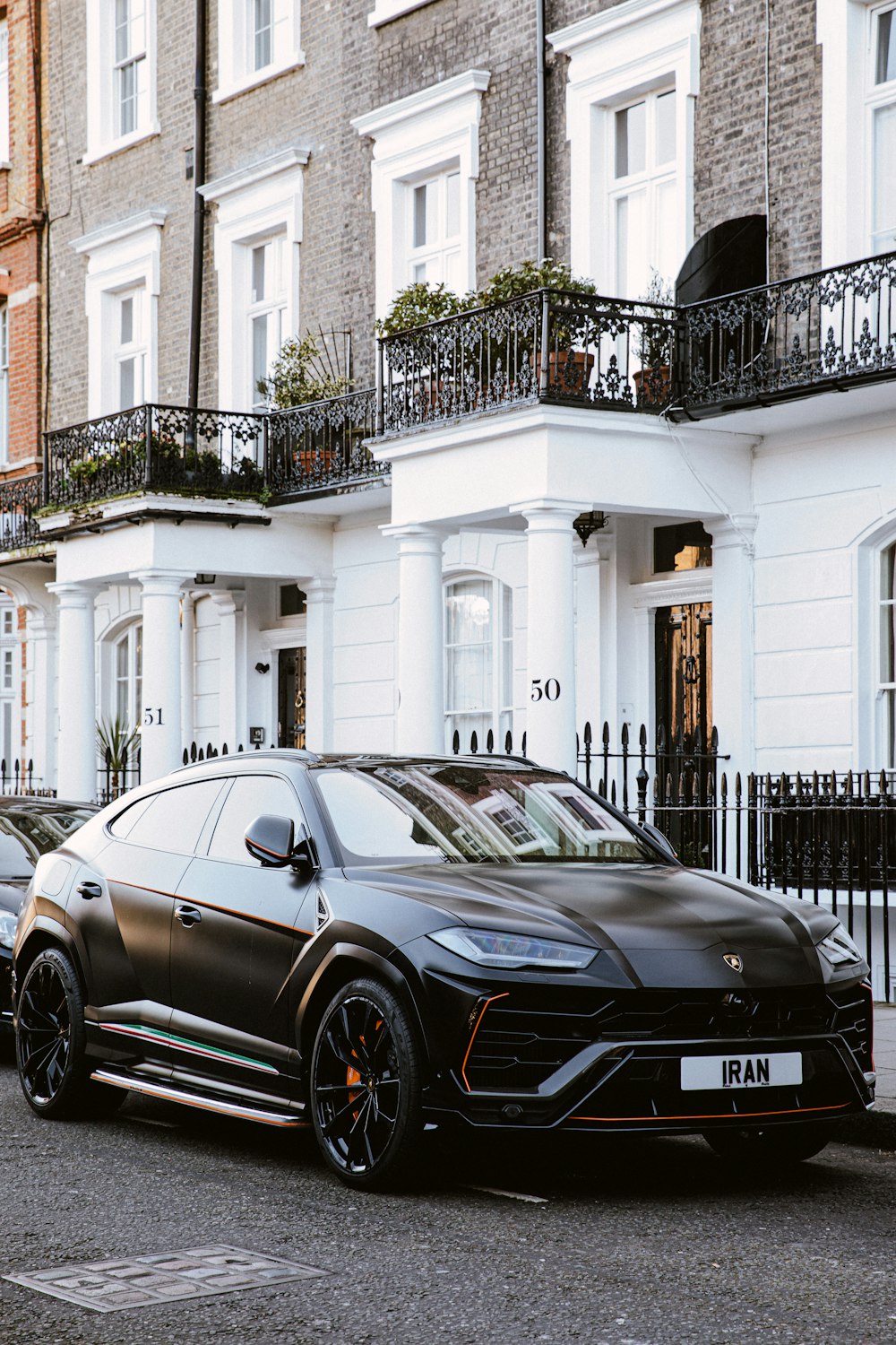 black bmw m 3 parked in front of white building