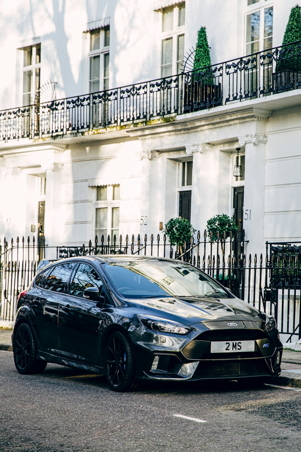 black bmw m 3 parked on sidewalk during daytime