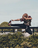 Dynamic shot of a Black man mid-motion, expressing freedom and culture against a pastel green backdrop.