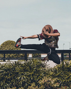 A vibrant illustration showing a person joyfully exercising outdoors, surrounded by symbols of growth like blooming flowers and a rising sun, embodying sustainable fitness habits.