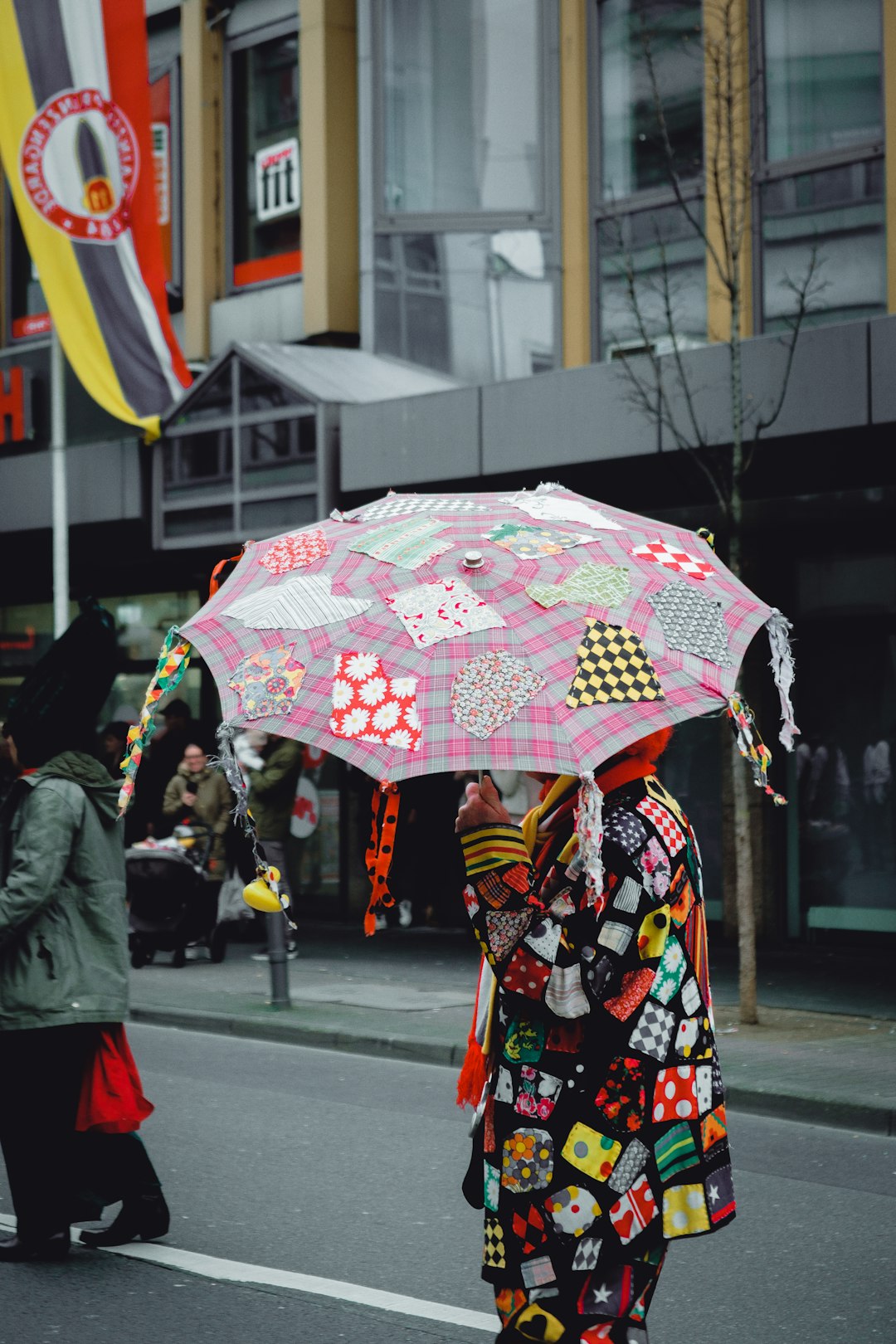 woman in red and white floral kimono holding umbrella walking on sidewalk during daytime