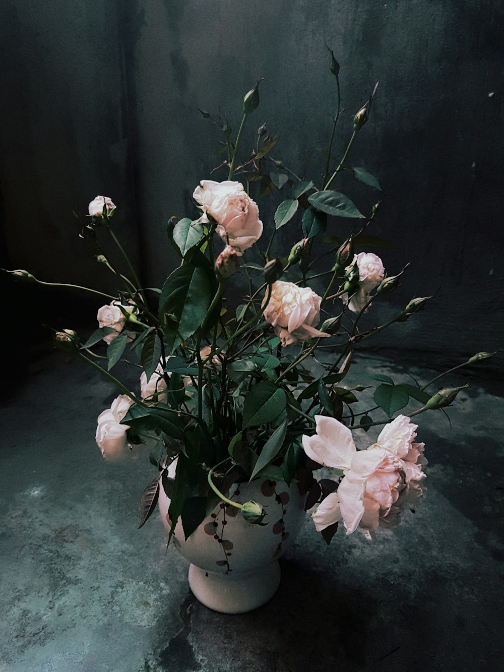 pink and white flowers on white ceramic vase