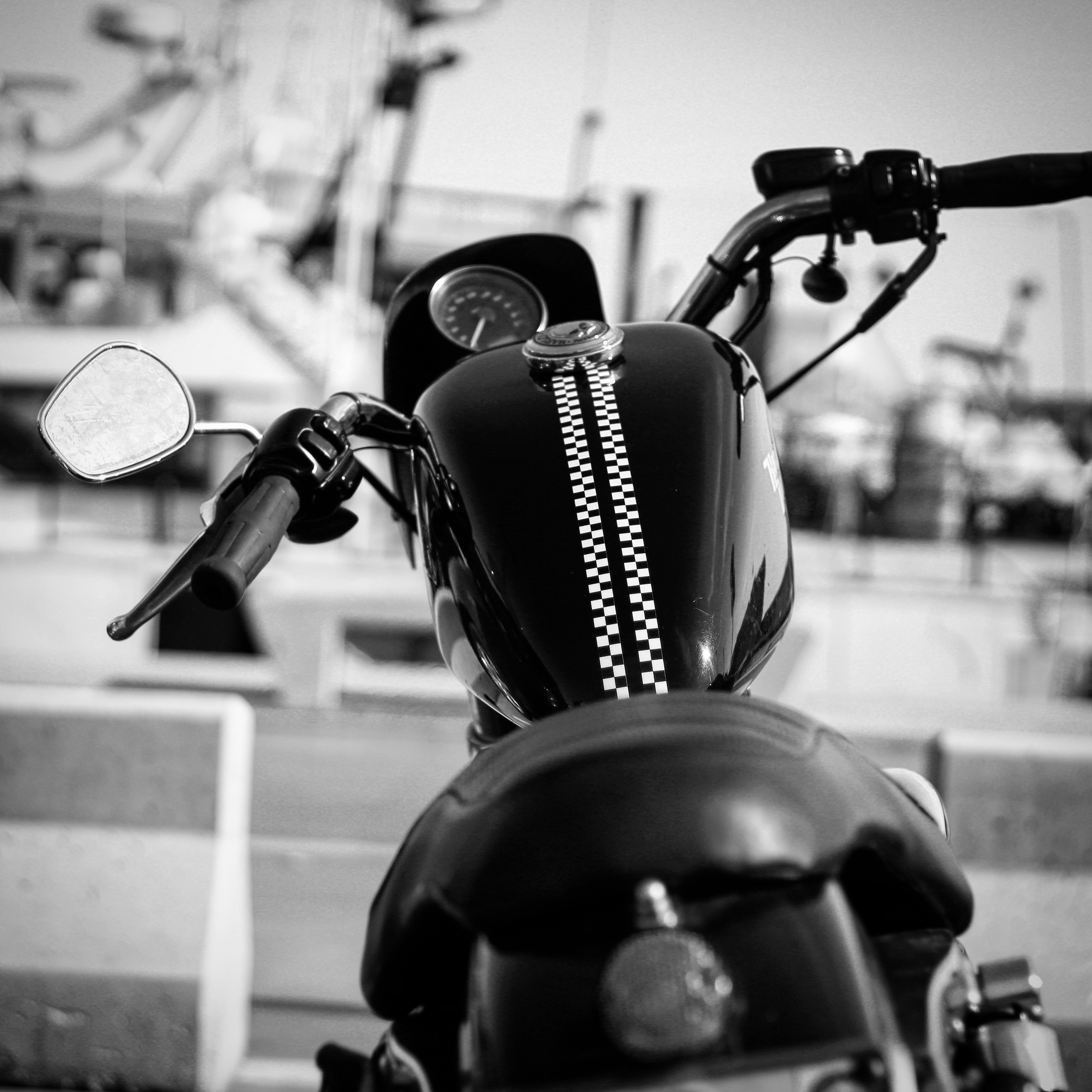 grayscale photo of motorcycle parked on sidewalk
