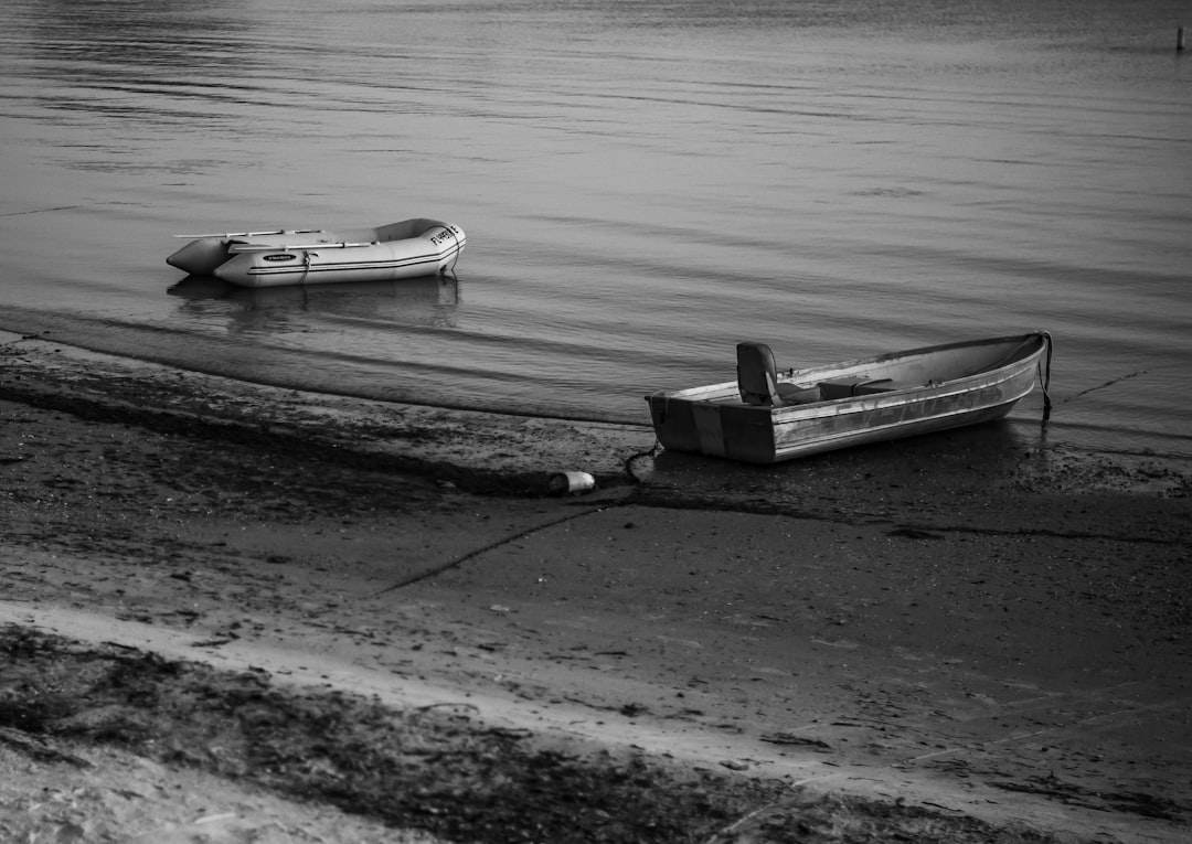 grayscale photo of boat on water