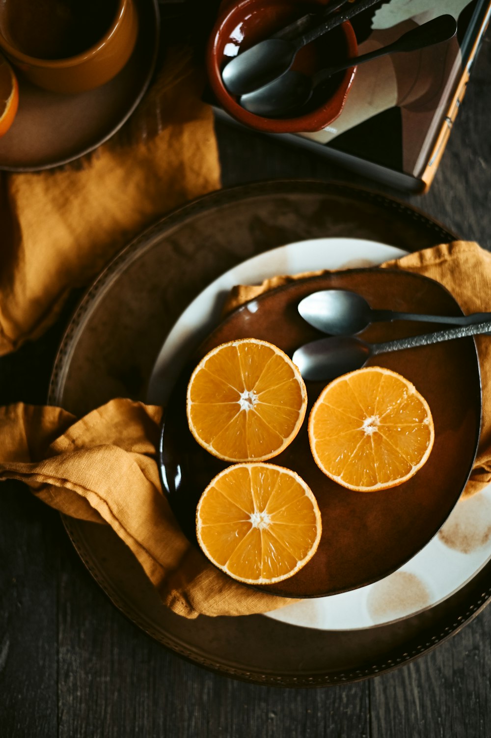sliced orange fruit on brown ceramic bowl