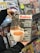 A person holding a magazine titled 'Kahve' shows a close-up of a coffee machine pouring espresso into a white cup. It features articles about franchising coffee shops and various coffee-related topics. In the background, there is a display of various other magazines on shelves.