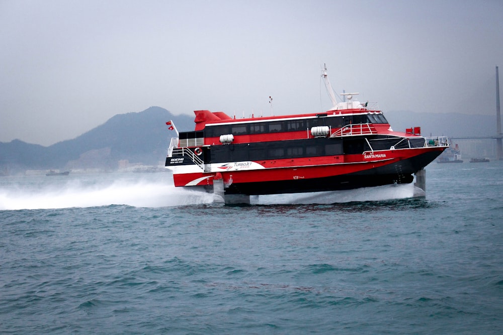 red and white boat on sea during daytime