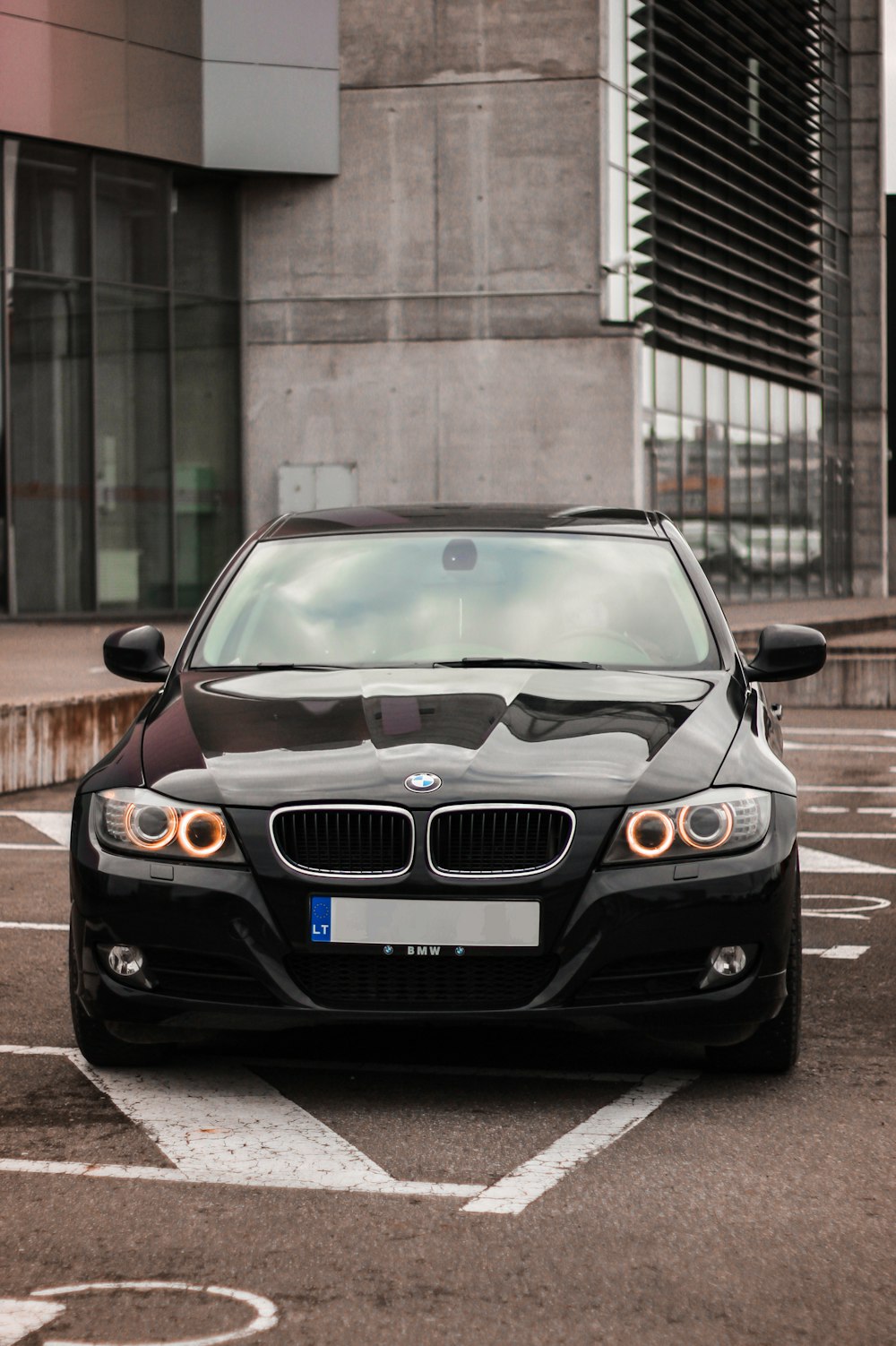 black bmw car parked on sidewalk during daytime