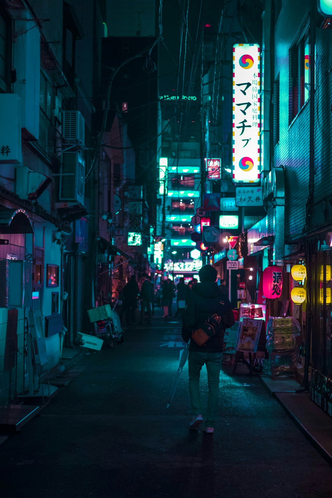 man in black jacket walking on street during nighttime