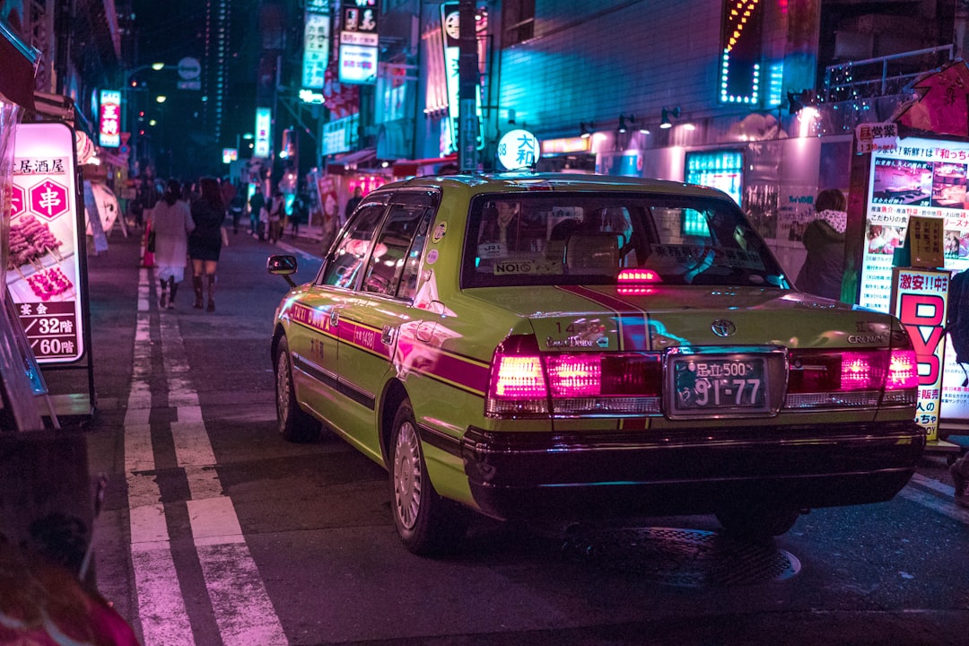 pink sedan on road during night time