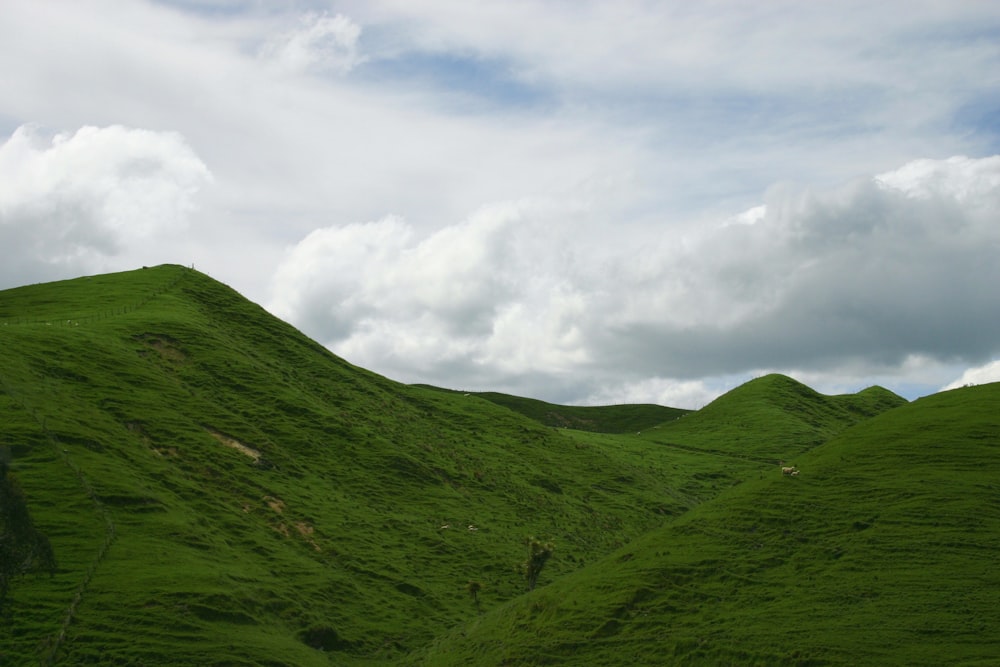 green mountain under white clouds during daytime