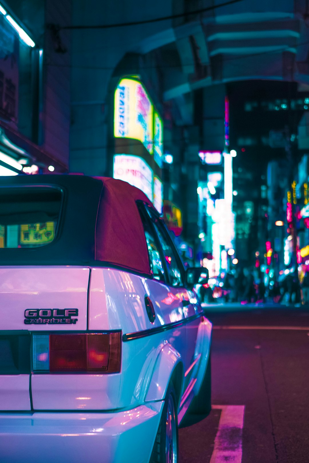 red car on the street during night time