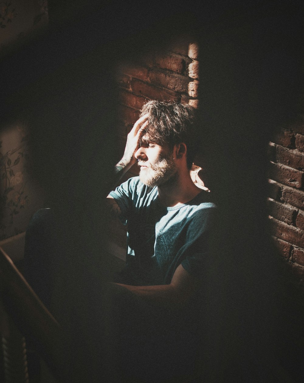 man in black t-shirt sitting on staircase