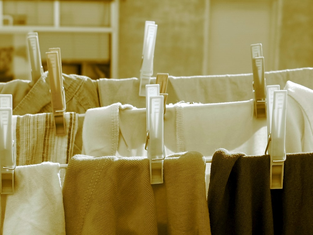 white plastic clothes hanger on brown textile