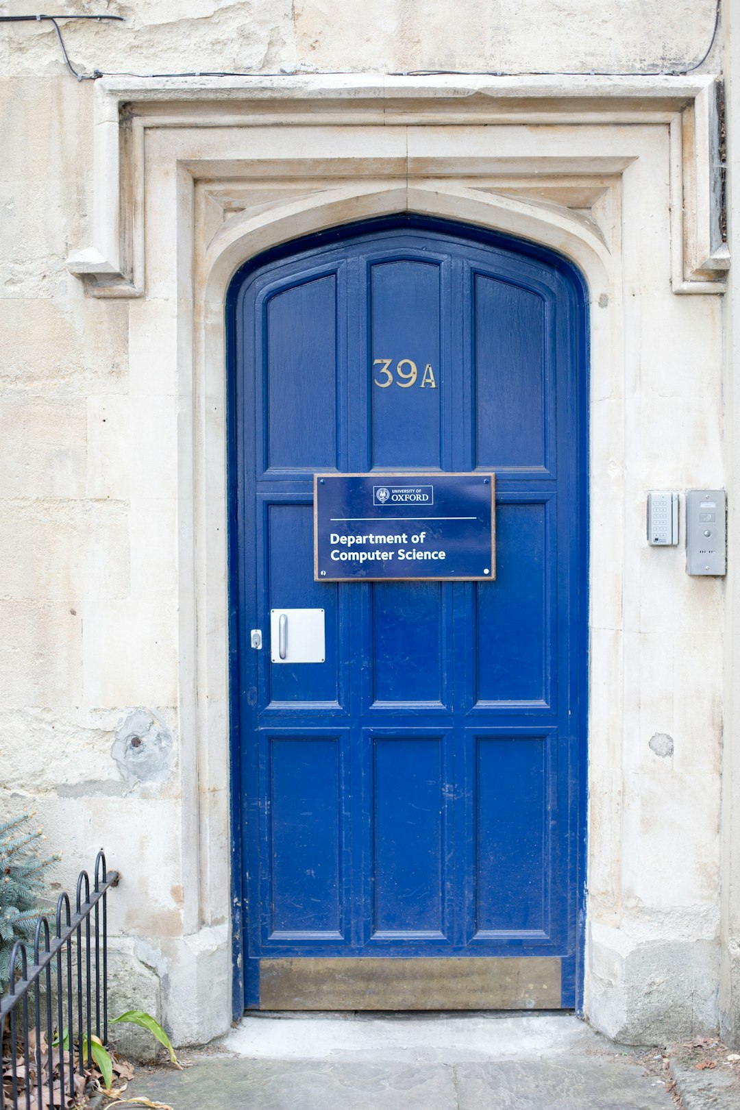 blue wooden door with white concrete wall