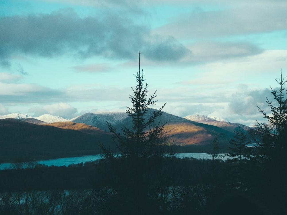 brown mountain under gray sky