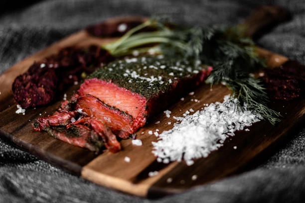 sliced meat on brown wooden chopping board