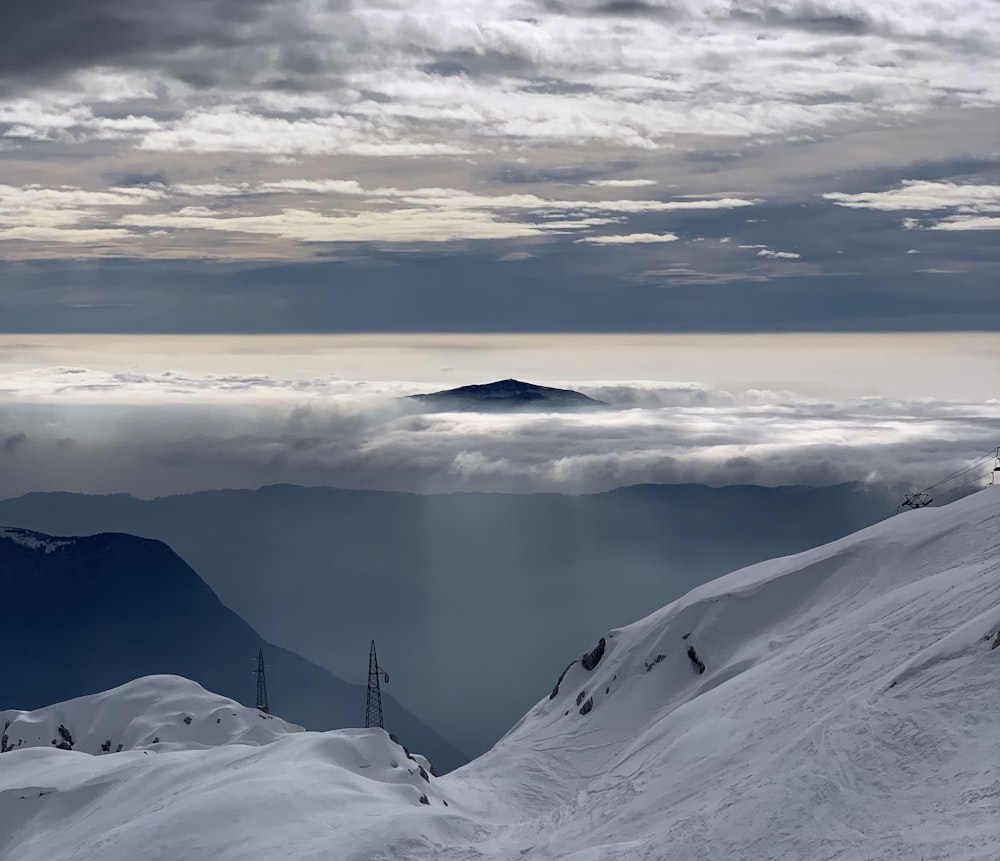 snow covered mountain under cloudy sky during daytime