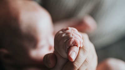 person holding babys feet